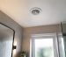 Bathroom extractor fan grille with cold air felt at the opening during a backdraft check