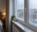 A realistic European bedroom window with morning condensation droplets on the inside of the glass and frame
