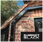 INABA DENKO SLIMDUCT SD Black Trunking System Installed On Brick Facade For Air Conditioner Refrigerant Pipes